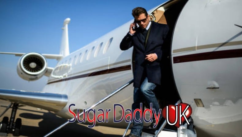 sugar daddy getting off a private plane well dressed talking on the phone